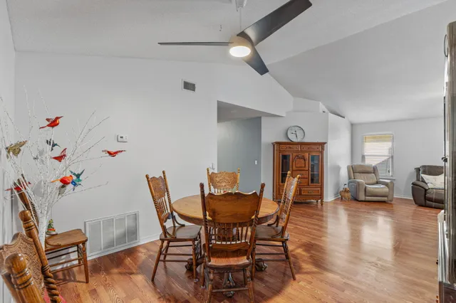 a dining room with furniture and wooden floor