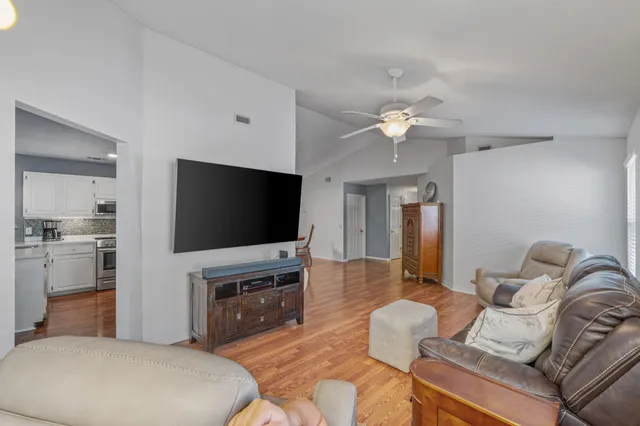 a living room with furniture and a flat screen tv