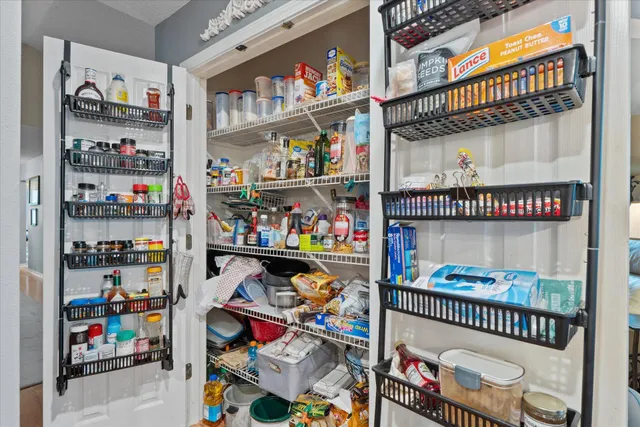 a living room with furniture a fireplace and a floor to ceiling window