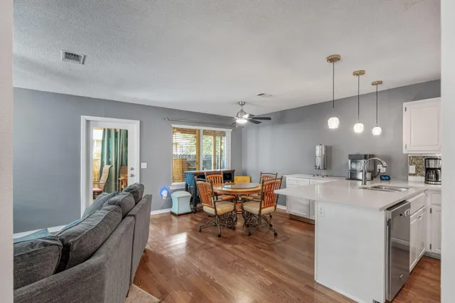 a living room with furniture a fireplace and a window