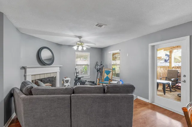 a view of a livingroom with furniture and a chandelier fan