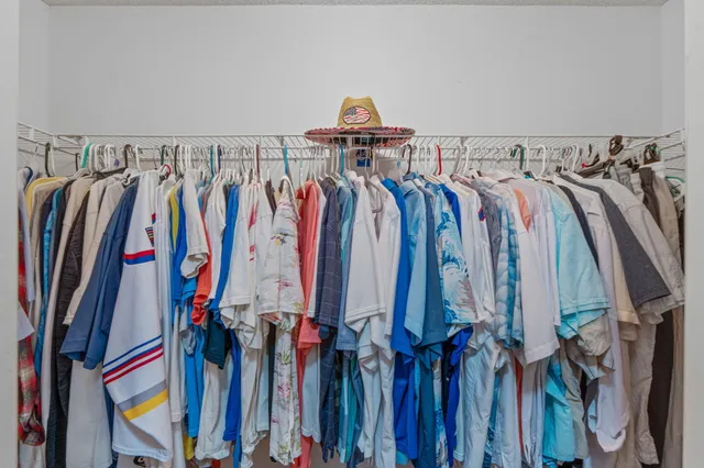 a bathroom with a granite countertop double vanity sink and a mirror