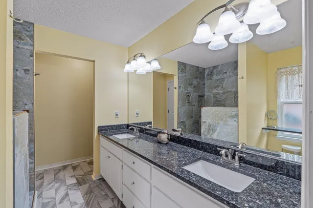 a bathroom with a shower and a sink