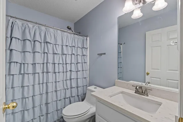a view of washer and dryer with kitchen in the background