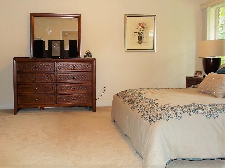 211 Foxchase Way Crestview, FL 32536 - Photo 13 of 24 a spacious bedroom with a bed and a lamp on dresser
