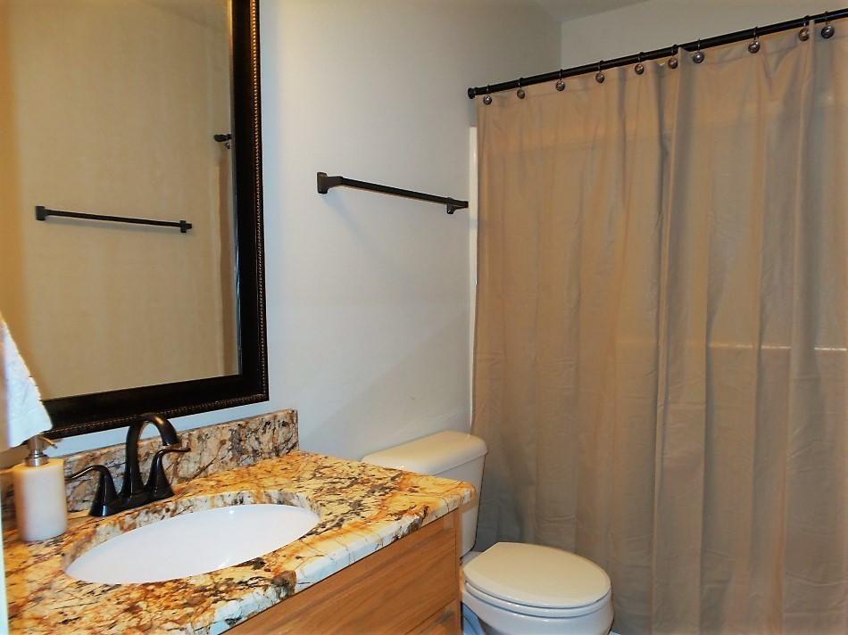 211 Foxchase Way Crestview, FL 32536 - Photo 19 of 24 a bathroom with a granite countertop sink toilet and a mirror