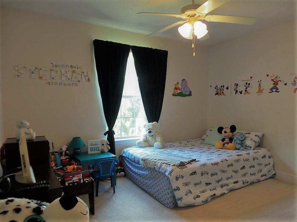 211 Foxchase Way Crestview, FL 32536 - Photo 20 of 24 a bedroom with a bed and a chandelier