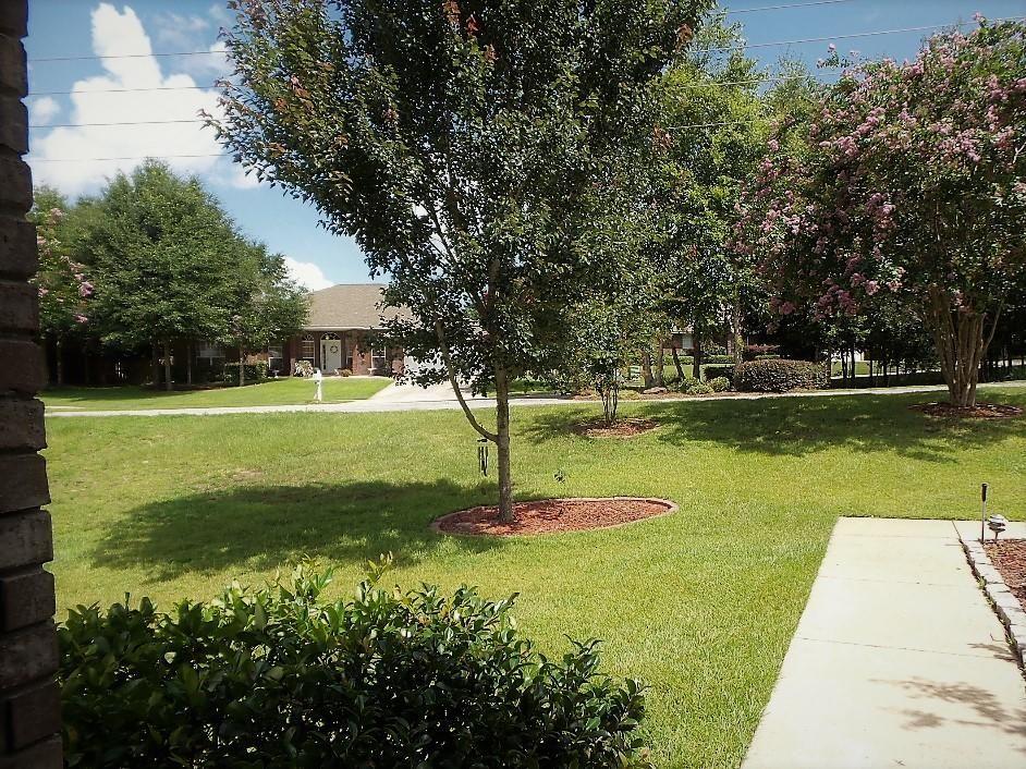 211 Foxchase Way Crestview, FL 32536 - Photo 3 of 24 a swimming pool with wooden fence