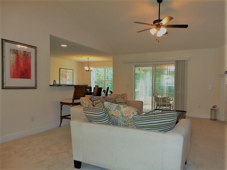 211 Foxchase Way Crestview, FL 32536 - Photo 5 of 24 a view of dining room and livingroom with furniture wooden floor a rug a chandelier