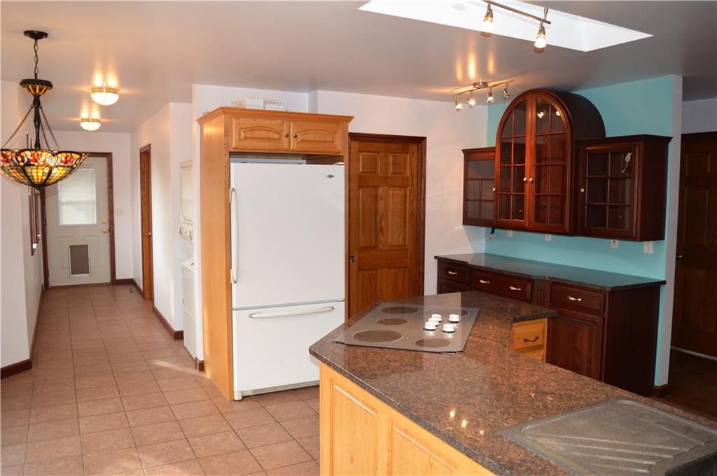 783 West Old Rte 422 Butler, PA 16001 - Photo 9 of 25 View from dining room to side exit of home, laundry area, and eat in kitchen nook, pantry door to right of refrigerator
