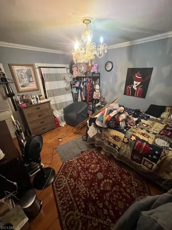 a bed room with two bed and a chandelier