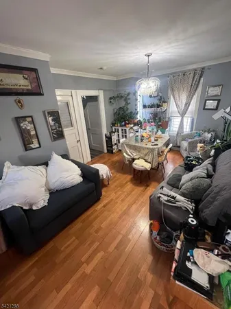 a living room with furniture and a chandelier