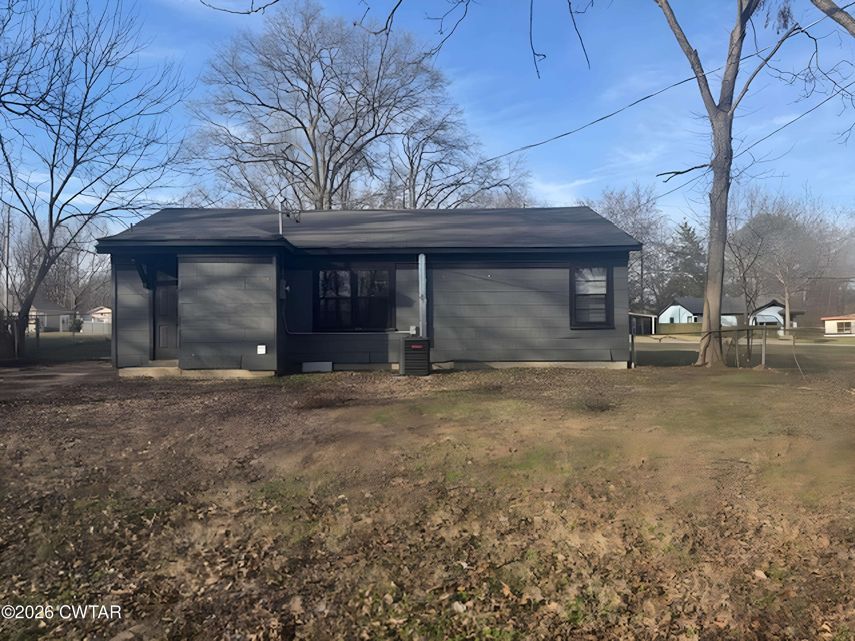 3043 Culpepper Saint Extension Milan, TN 38358 - Photo 2 of 8 a front view of a house with a yard and garage