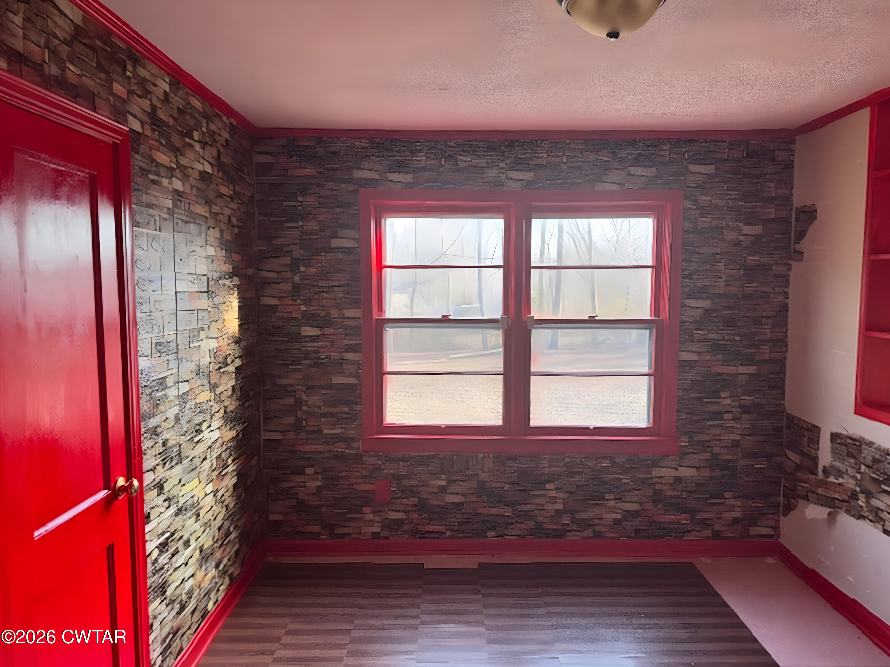 3043 Culpepper Saint Extension Milan, TN 38358 - Photo 4 of 8 a view of a room that has a bed and wooden floor
