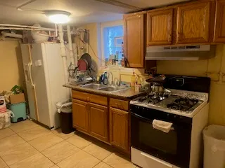 a kitchen with stainless steel appliances granite countertop a stove a refrigerator and a sink