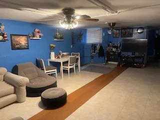 a living room with furniture a chandelier and a flat screen tv