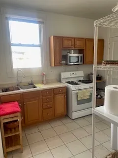a kitchen with a stove sink and microwave