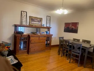 a view of a dining room with furniture and chandelier