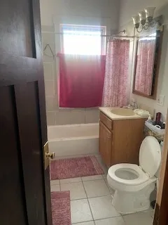 a bathroom with a sink a toilet a mirror a vanity and bathtub