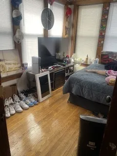 a kitchen with a stove and a wooden floor