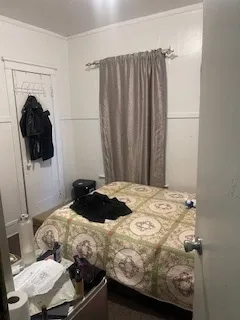 a bedroom with a bed and a chair