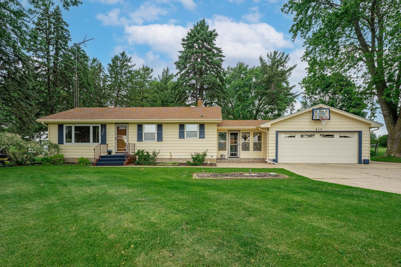 852 West Fairgrounds Road Freeport, IL 61032 - Photo 19 of 33 a front view of a house with a garden and trees