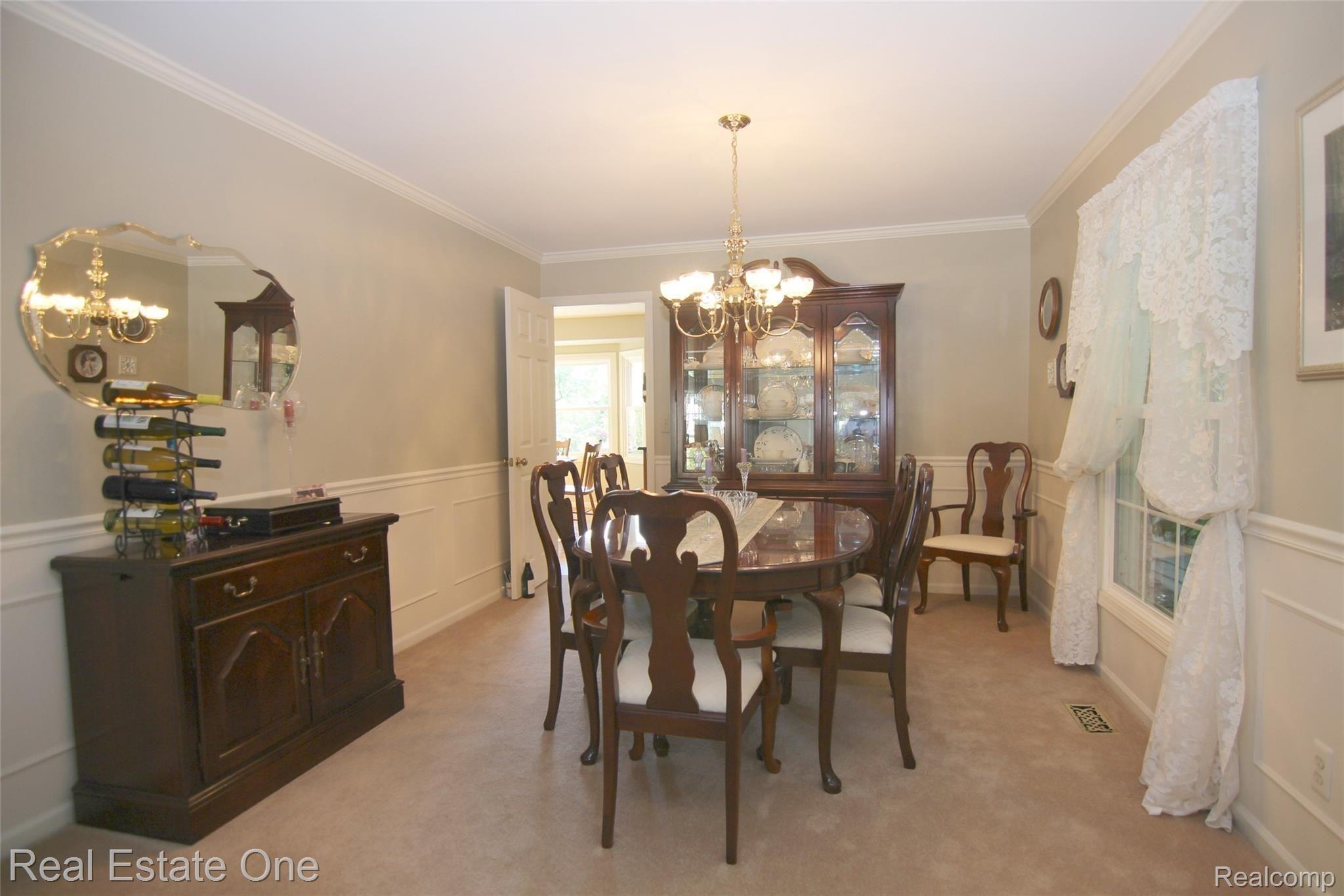 21602 Welch Road Northville, MI 48167 - Photo 15 of 29 Formal dining with crown molding and formal trim.