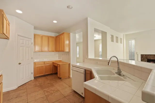 a kitchen with stainless steel appliances granite countertop a sink a stove and a refrigerator