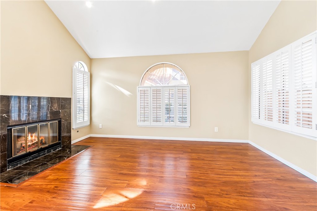 68 Marbella Aisle, Unit 34 Irvine, CA 92614 - Photo 3 of 38 The loving room features vaulted ceilings, natural light and a lovely fireplace.