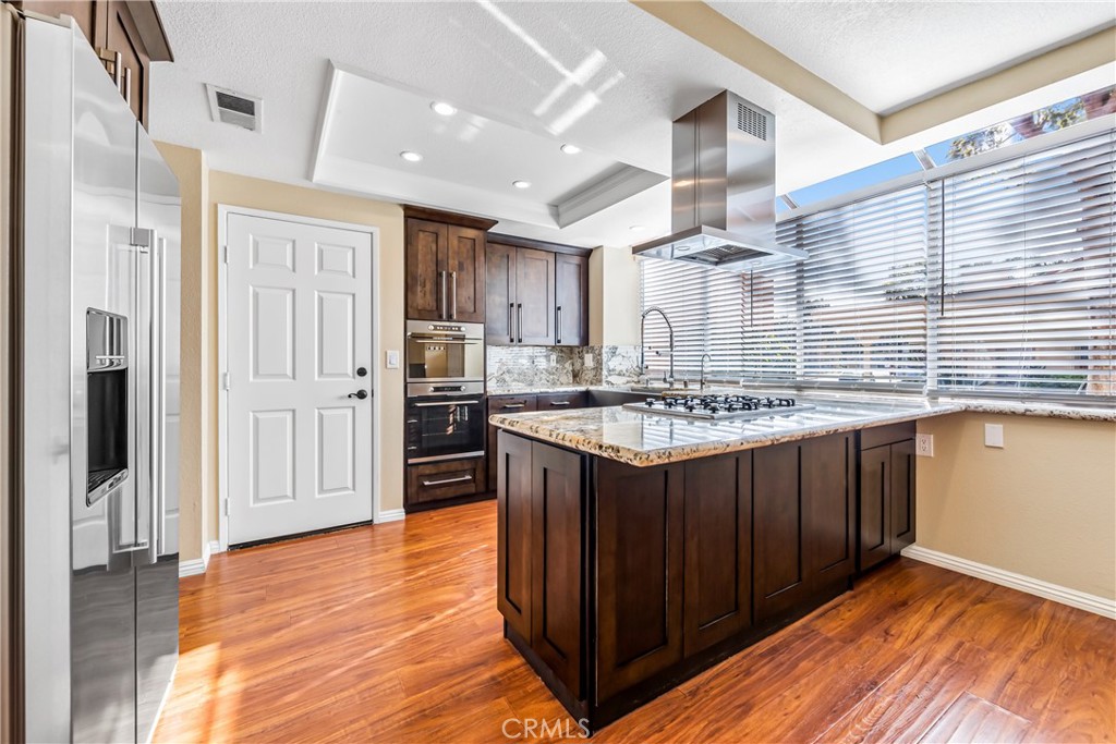 68 Marbella Aisle, Unit 34 Irvine, CA 92614 - Photo 5 of 38 Upgraded kitchen has stainless appliances, wall to wall windows, and direct access to the attached private garage.