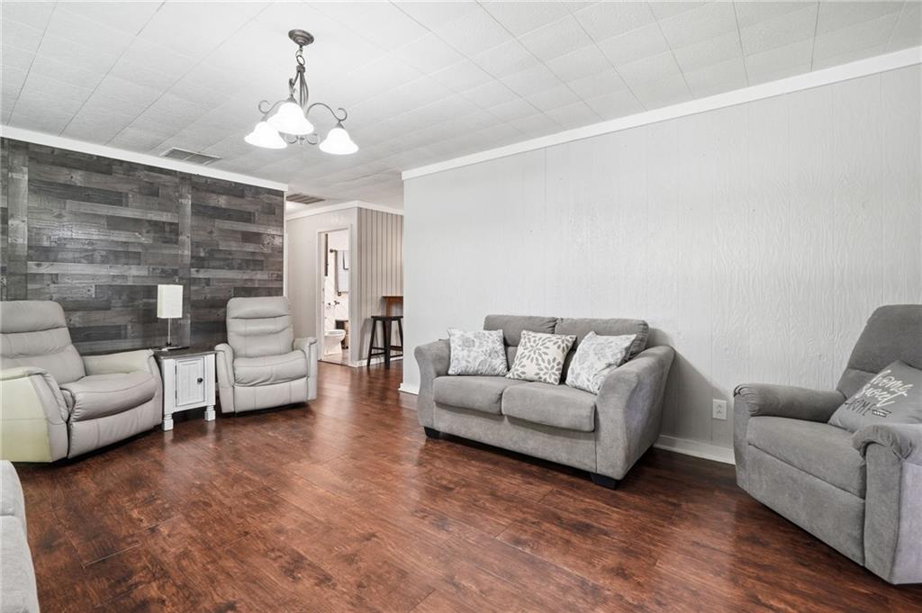 1709 Harrington Road Ball Ground, GA 30107 - Photo 10 of 46 a living room with furniture and a chandelier