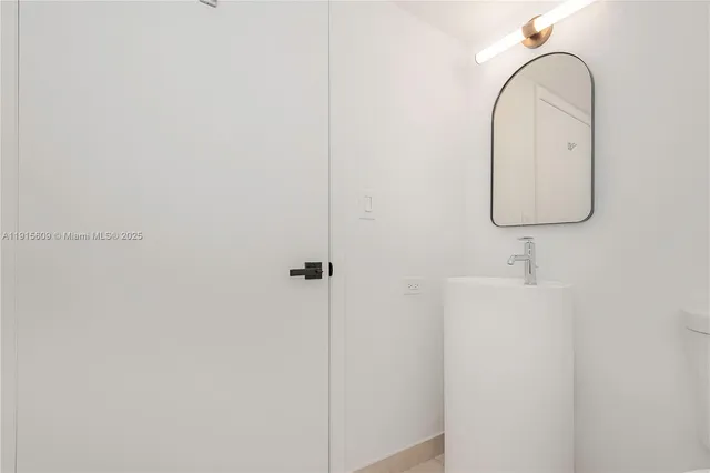 a bathroom with a sink and mirror
