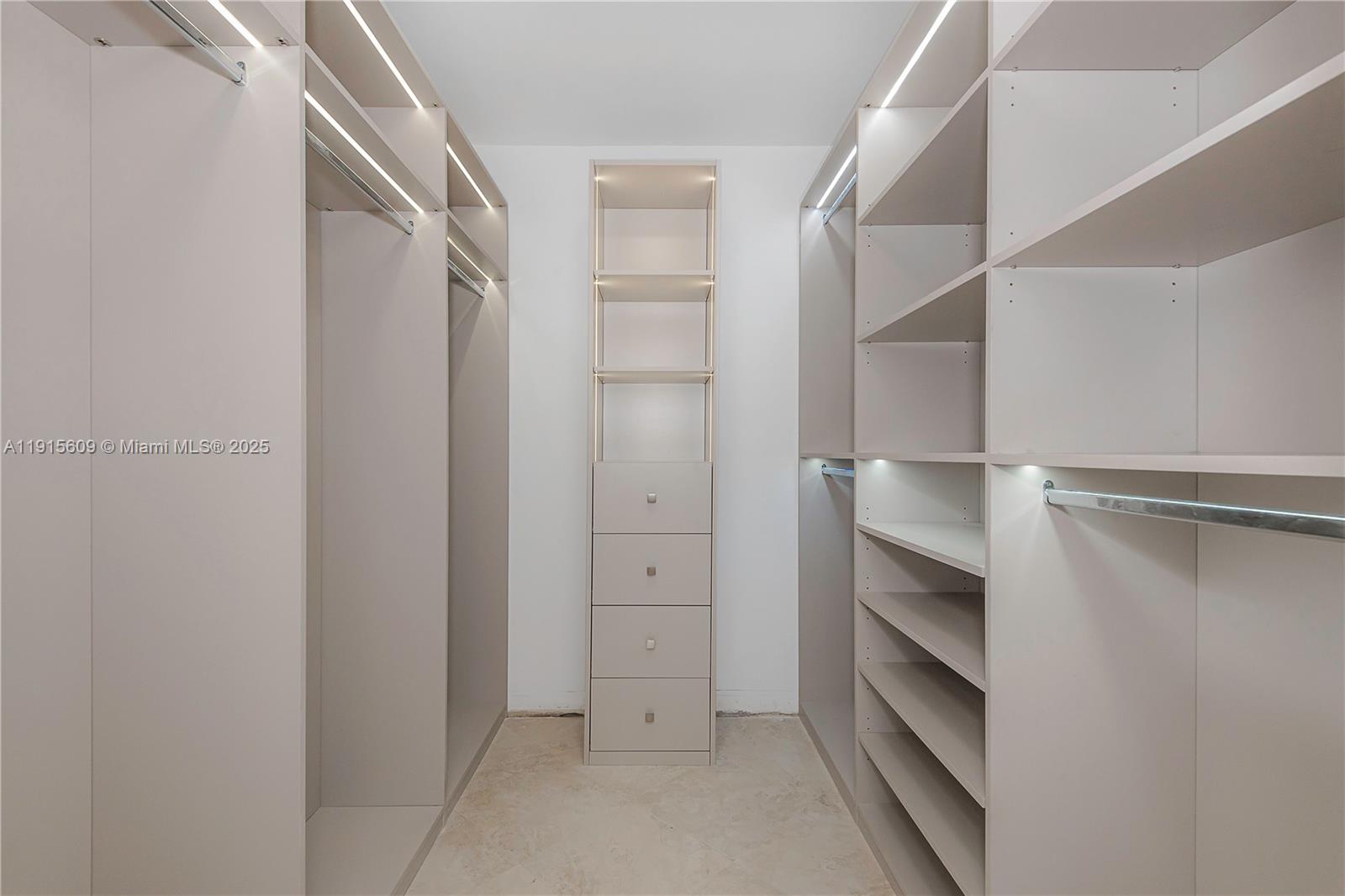 8855 Collins Avenue, Unit 6E Surfside, FL 33154 - Photo 15 of 24 a view of walk in closet with empty racks
