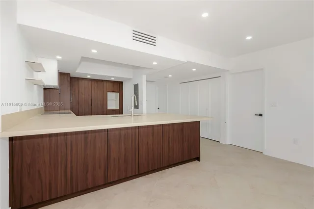 a spacious bathroom with a granite countertop sink and a mirror