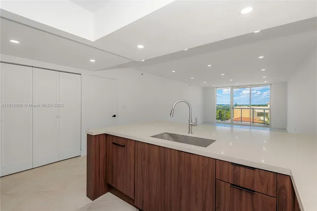 a kitchen with stainless steel appliances granite countertop a sink and a granite counter tops