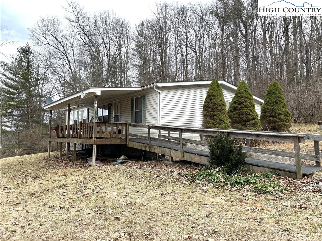223 Poplar Lane Lansing, NC 28643 - Photo 1 of 12 a backyard of a house with wooden floor and outdoor seating