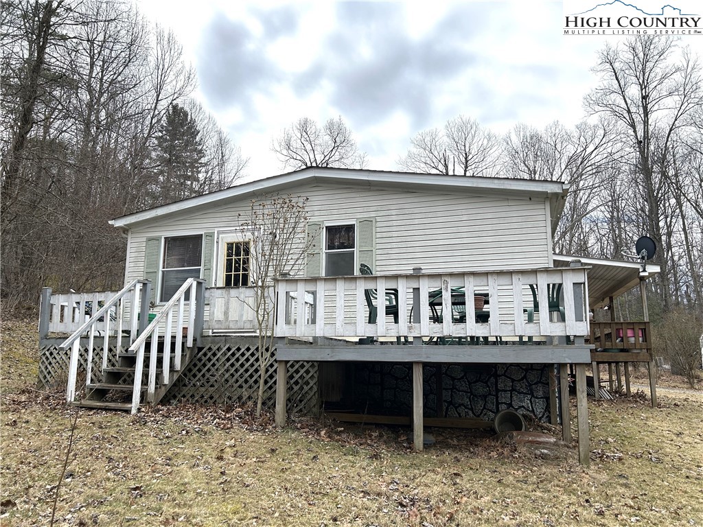 223 Poplar Lane Lansing, NC 28643 - Photo 2 of 12 a backyard of a house with table and chairs