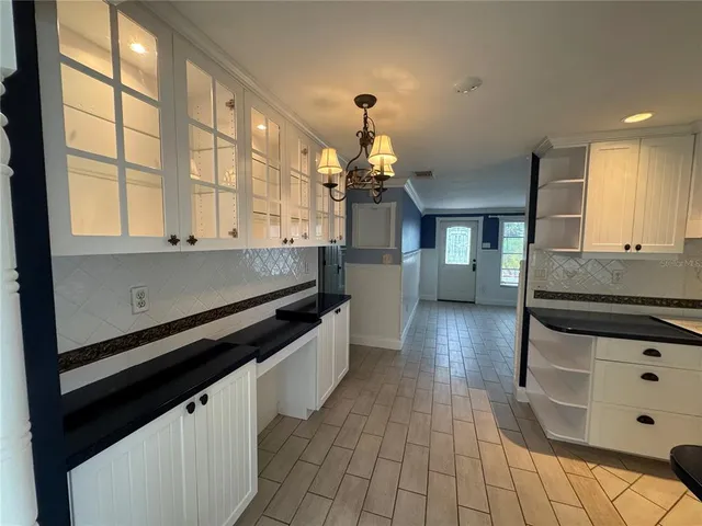a kitchen with stainless steel appliances a sink stove and cabinets