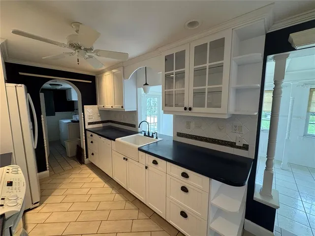 a kitchen with stainless steel appliances a refrigerator and a stove top oven