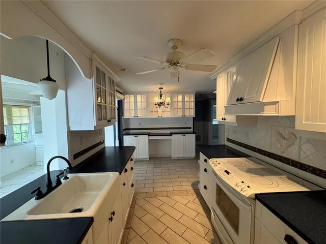 a kitchen with a sink appliances and cabinets
