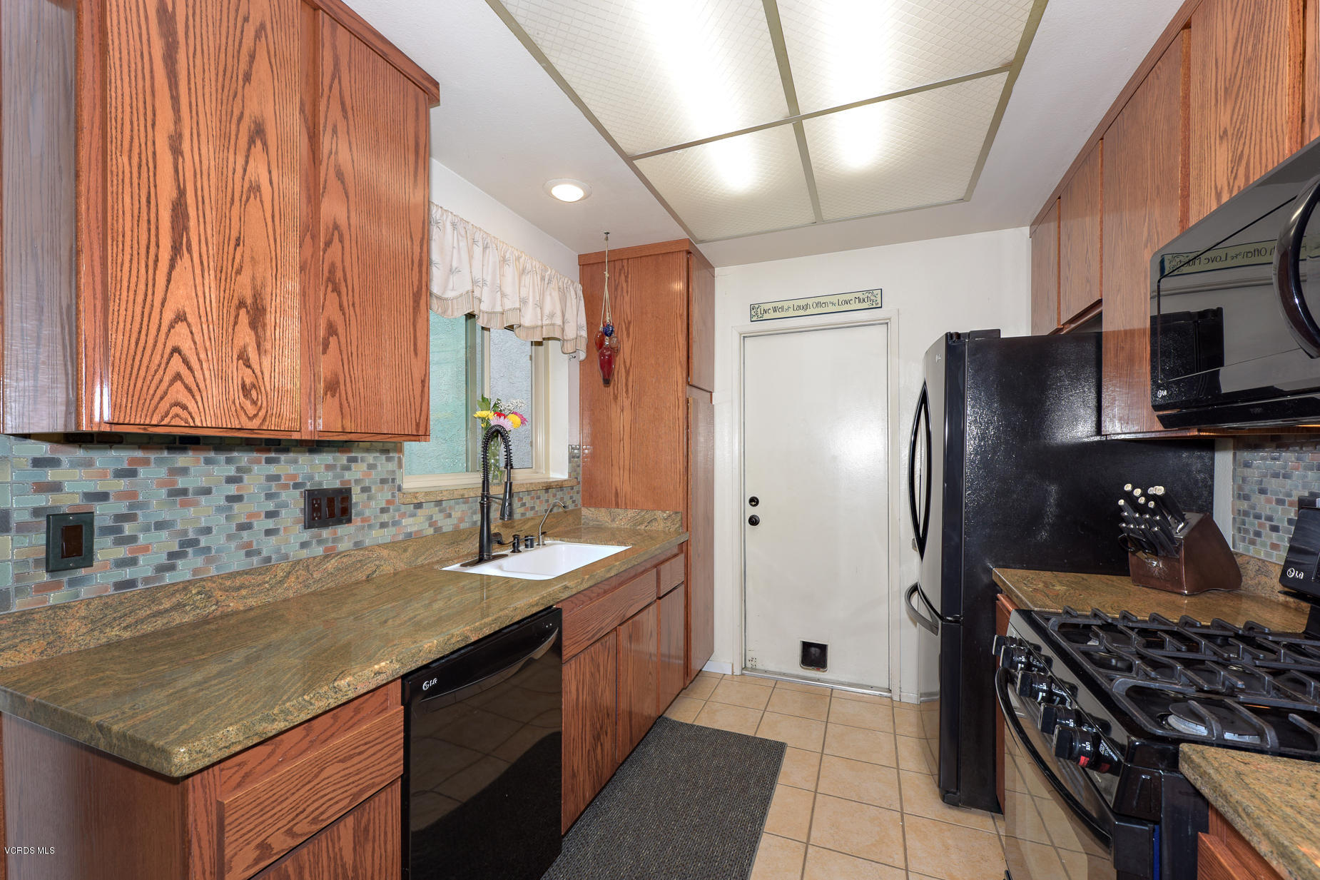 447 Reed Way Port Hueneme, CA 93041 - Photo 14 of 38 a kitchen with stainless steel appliances granite countertop a sink stove and refrigerator