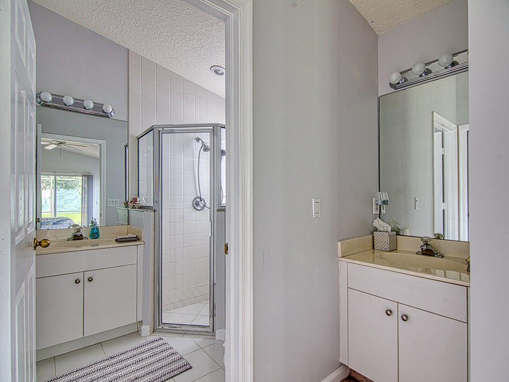 2758 Southwest Montego Terrace Stuart, FL 34997 - Photo 11 of 22 Master bath with 2 sinks and shower with glass doors.