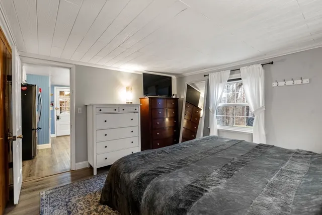 a bed room with a bed and a television