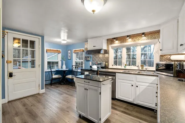 a kitchen with counter top space a sink and appliances