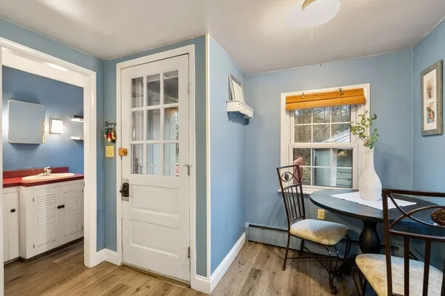 a view of a room with wooden floor lounge chair and windows