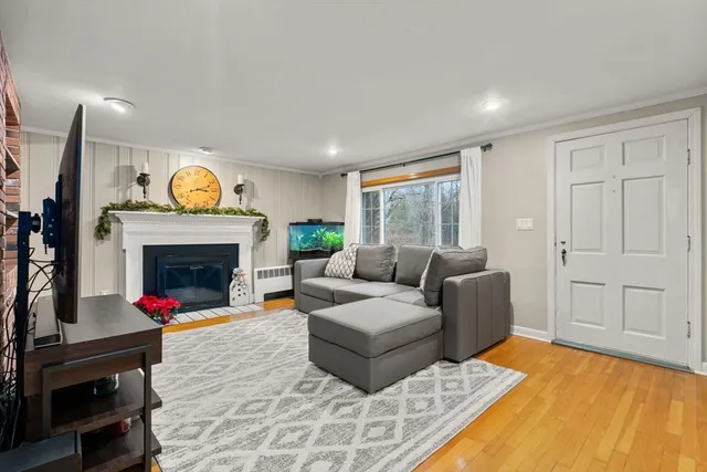 a living room with furniture a fireplace and a flat screen tv