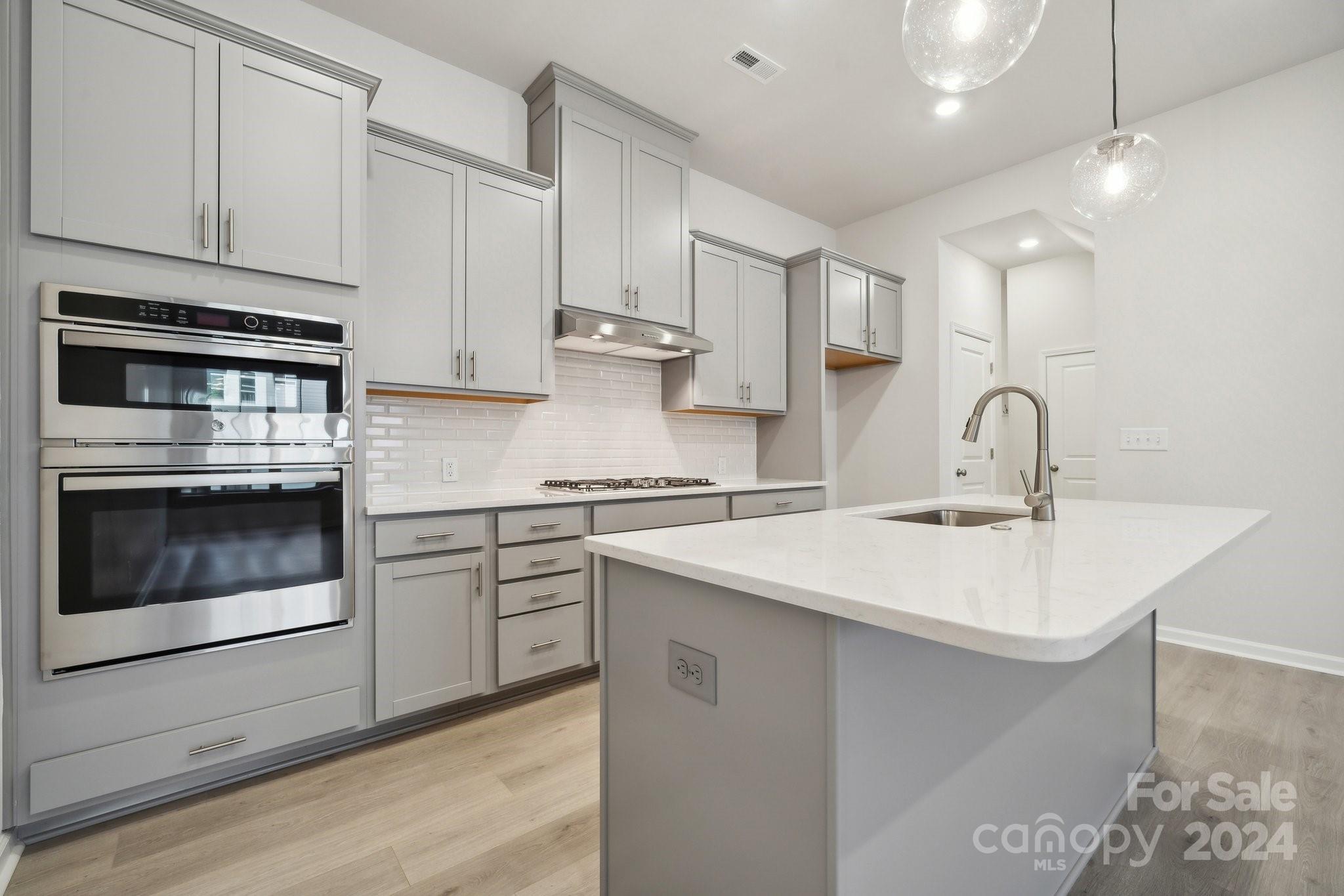 1174 Lost Cv Road Indian Land, SC 29707 - Photo 4 of 27 a kitchen with white cabinets stainless steel appliances and sink
