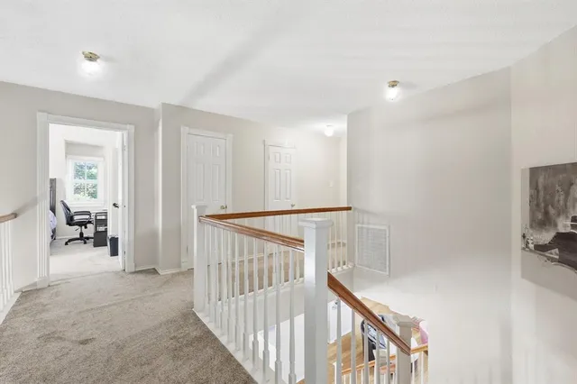 a view of hallway with livingroom and furniture