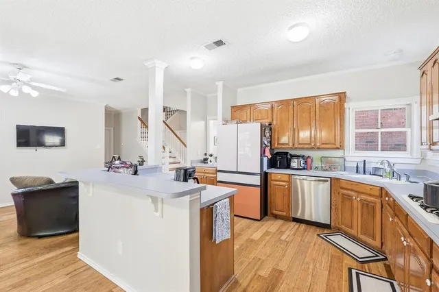 a kitchen with a sink stove and cabinets