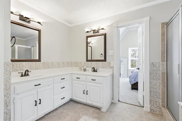 a bathroom with a double vanity sink and mirror